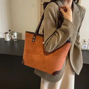 Detail view of large caramel tote bag with reinforced corners and long shoulder straps