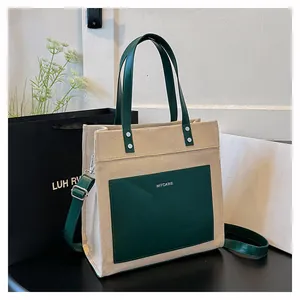 Detailed close-up of beige canvas and dark green PU leather tote bag with MYCARE logo