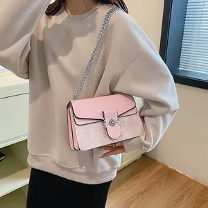 Pink vintage chain bag with floral prints shown on a model for actual size and fit