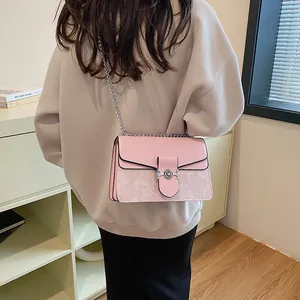 Pink leather chain bag with floral pattern shown on model for size and fit
