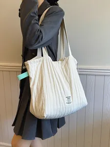 Minimalist beige quilted nylon drawstring tote bag with black logo patch for women