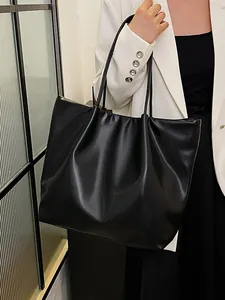 Large black matte leather tote bag with pleated design for casual everyday shoulder wear