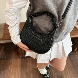 Detail of black pleated cloud hobo bag featuring soft leather texture and silver hardware