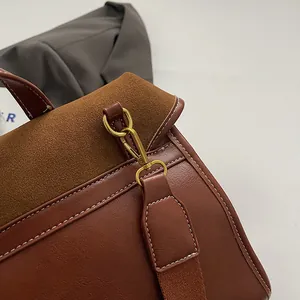 Detailed macro view of brown faux suede and leather texture with white stitching