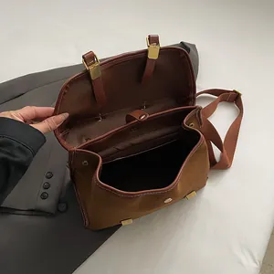 Top view of vintage brown crossbody bag showing spacious interior and contrast textures