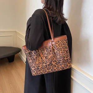 Detail of large leopard print tote bag with brown leather straps for autumn winter