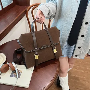 Detail of vintage brown matte leather briefcase with golden buckles and stitching