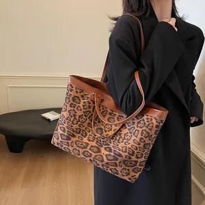 Leopard print tote bag model shot showing large capacity and stylish brown leather strap