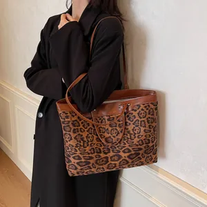 Detail of leopard print tote bag with brown faux leather trim and sturdy dual handles