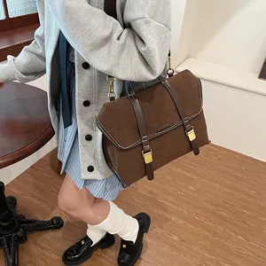 Detail of vintage brown frosted leather backpack with twin vertical straps and gold buckles