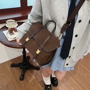Detail of vintage brown matte leather backpack with brass buckle and top handle