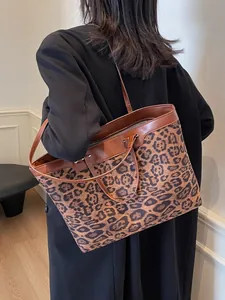 Leopard print tote bag with brown leather straps shown on a model for daily commute