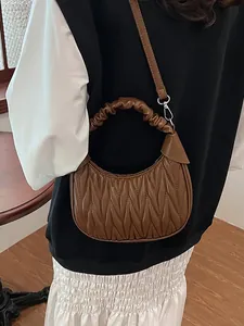 Brown ruched cloud hobo bag with pleated texture and adjustable strap for women