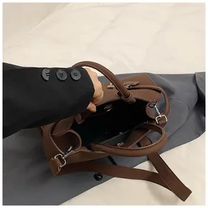 Top view of open dark brown leather tote bag showing spacious interior and silver hardware