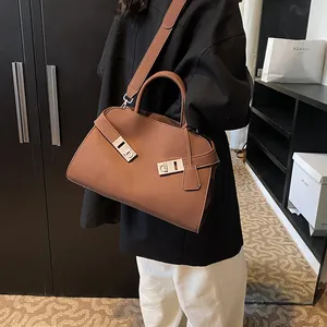 Brown matte leather handbag with silver Gancini buckles and detachable shoulder strap