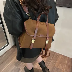 Close-up of retro brown backpack with matte texture and gold metal buckles for daily commute