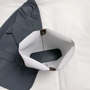 Top view of large tote bag interior showing spacious light lining and magnetic metal clasp
