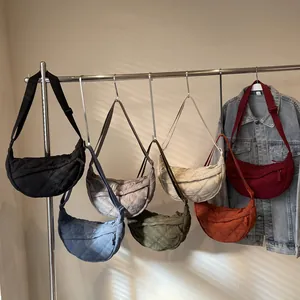 Quilted crescent bags in various colors showing nylon texture and adjustable straps