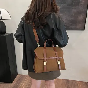 Close-up of brown matte faux suede backpack with gold hardware and side storage details