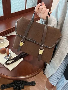 Retro brown suede briefcase style backpack with gold buckles and white contrast stitching