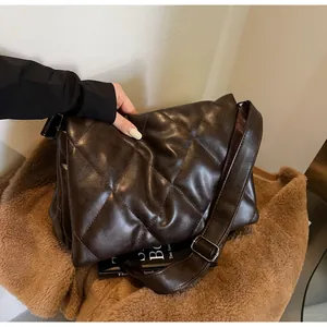 Détails du cuir synthétique matelassé marron foncé et de la large bandoulière réglable