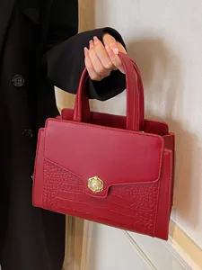 Elegant red crocodile texture leather tote bag with vintage pearl clasp held by model