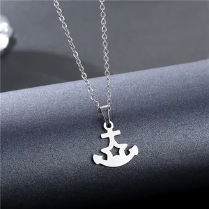 Polished stainless steel anchor pendant necklace with star cutout on grey display