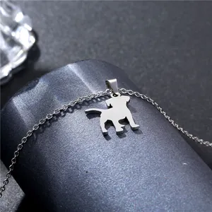 Polished stainless steel dog silhouette pendant necklace on a sleek gray display