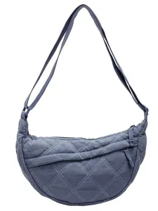 Navy blue quilted crescent shoulder bag with white contrast stitching and adjustable strap