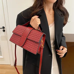 Detail of red woven texture on a fashion evening handbag with gold hardware