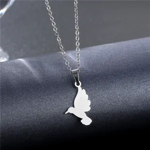 Minimalist stainless steel hummingbird necklace with hollow bird pendant on grey background