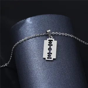 Cool stainless steel razor blade pendant necklace with shiny silver finish on display stand