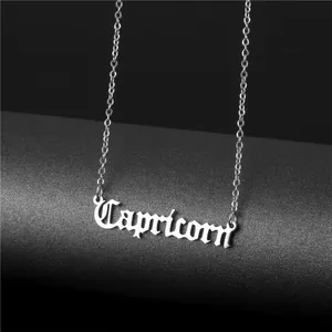 Macro detail of silver stainless steel Capricorn zodiac pendant with gothic lettering