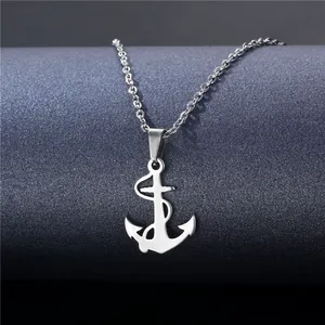 Polished silver anchor cross pendant necklace with fine chain on a textured grey background
