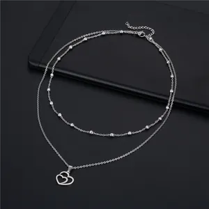 Double-layered stainless steel heart necklace with polished beads and cutout pendant