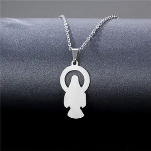 Macro shot of silver stainless steel pendant featuring a polished religious silhouette