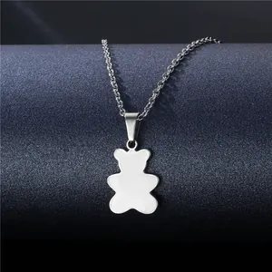 Macro shot of silver polished teddy bear pendant on a delicate steel link chain