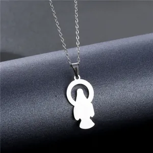 Macro detail of silver religious pendant with saint silhouette on steel chain