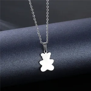 Detailed view of a polished stainless steel bear silhouette pendant on a silver O-chain