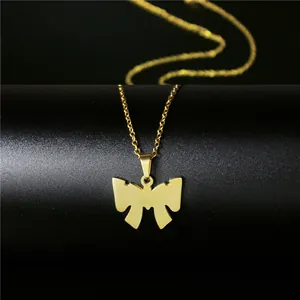 Macro detail of golden butterfly pendant with glossy finish on a 18K gold necklace