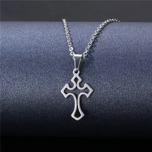 Macro shot of polished silver gothic hollow cross pendant with sleek metal chain necklace