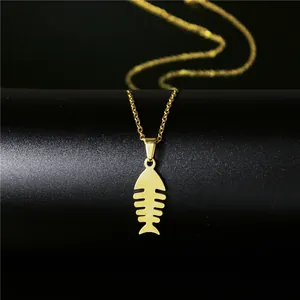Macro detail of a 18K gold-plated stainless steel fishbone pendant on a fine link chain