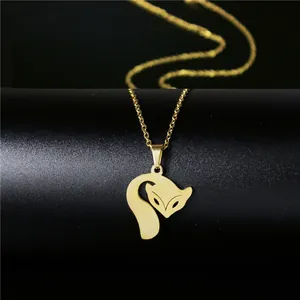Detail shot of a minimalist 18K gold-plated fox pendant necklace on a black stand