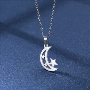 Macro detail of stainless steel crescent moon and hollow stars pendant with silver chain