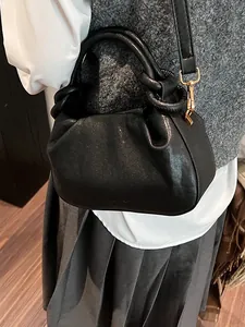 Premium black ruched cloud bag with unique knotted handle and gold metal hardware