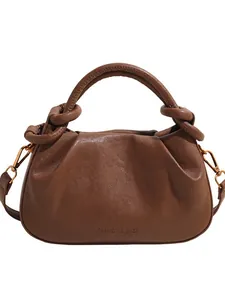 Deep brown ruched cloud bag with knotted top handle and adjustable shoulder strap