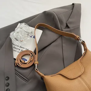 Vue détaillée du sac bandoulière en cuir camel avec coutures fines et boucles en argent
