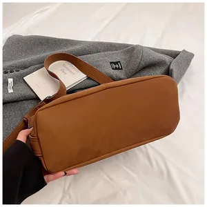 Detailed bottom view of a brown vintage tote bag with soft matte leather texture