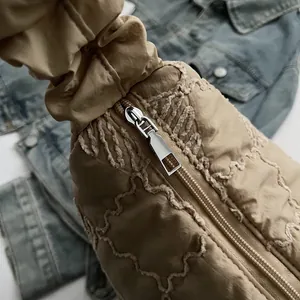 Detailed macro view of high-quality silver zipper and khaki quilted fabric on hobo bag