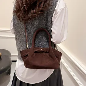 Deep brown suede tote bag with bow detail shown on a model for autumn style